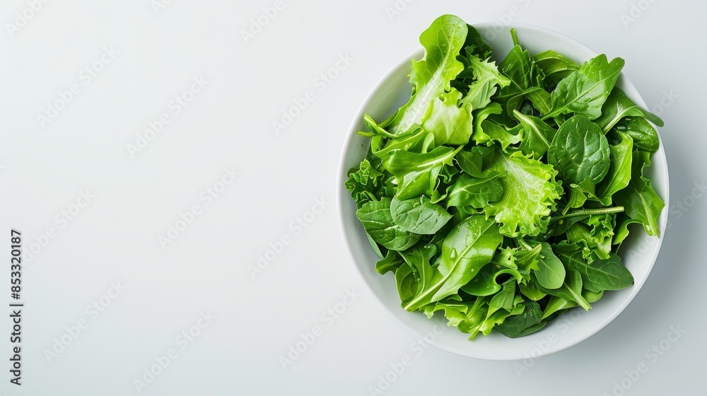 Freshly prepared green salad on a white table, ready to serve, clean and minimalist banner, ample room for copy Freshly prepared green salad on a white table, ready to serve, clean and minimalist banner, ample room for copy