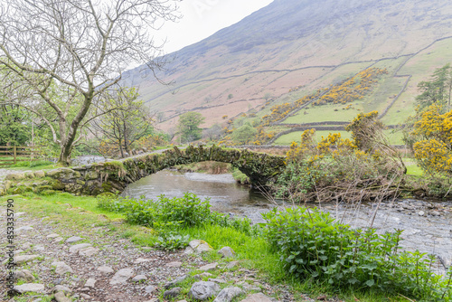 Stone arch bridge across a small stream in Lake District National Park. photo