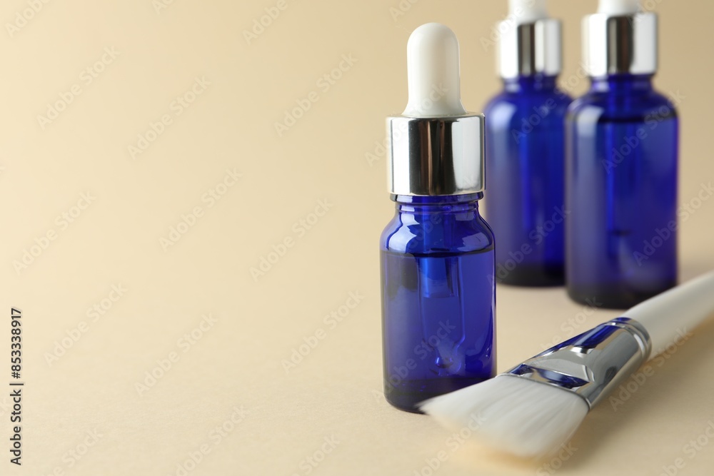 Peeling procedure. Bottles of chemical peel and brush on beige background, closeup. Space for text Peeling procedure. Bottles of chemical peel and brush on beige background, closeup. Space for text