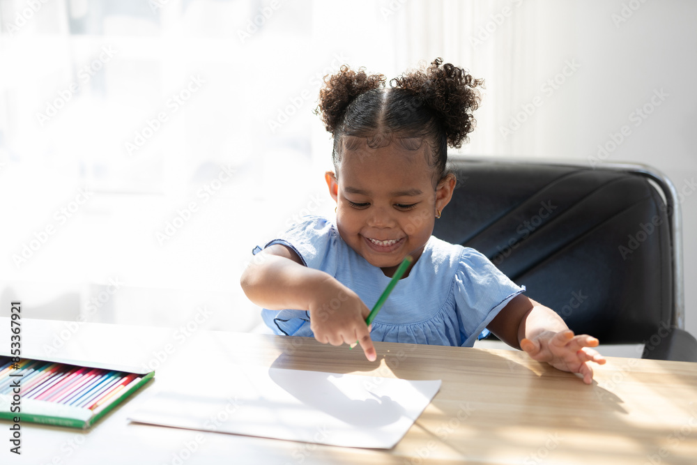 African child girl drawing with color pencil on paper African child girl drawing with color pencil on paper