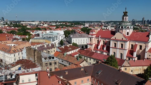Wallpaper Mural Aerial view of Vilnius old town featuring red rooftops, Gediminas Tower on a hill, and modern skyline buildings under a clear blue sky. Torontodigital.ca