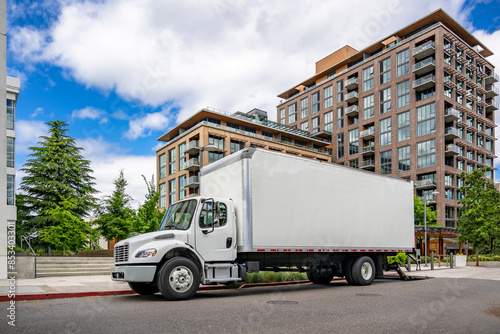 Konstfotografi Compact powerful bonnet day cab middle duty rig semi truck carry goods in box ta