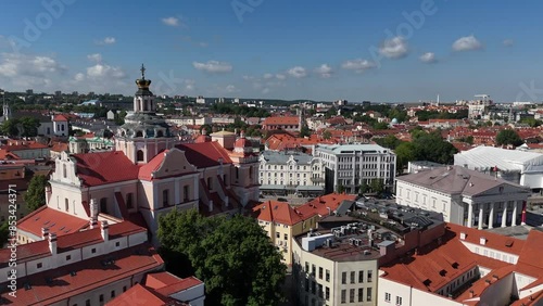 Wallpaper Mural Close-up aerial view of a church dome in Vilnius old town, with the cityscape and red rooftops visible in the background under a partly cloudy sky. Torontodigital.ca