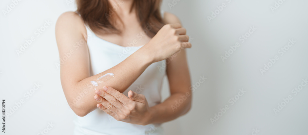 Skin care lotion and Skin body cream Moisturizing, Sunscreen and Healthy Daily Routine concepts. Beauty Woman applying moisturizing skincare cream on arm and body at home Skin care lotion and Skin body cream Moisturizing, Sunscreen and Healthy Daily Routine concepts. Beauty Woman applying moisturizing skincare cream on arm and body at home