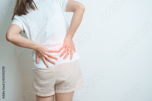 woman having back body ache during at home. adult female with muscle pain due to Piriformis Syndrome, Low Back Pain and Spinal Compression. Office syndrome and medical concept