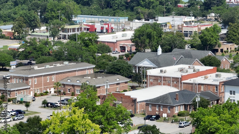 Fototapeta premium Historic Kingstree, South Carolina downtown buildings, architecture, streets, business, homes in small town USA in the South with shade trees by Black River on Sunny afternoon in summer