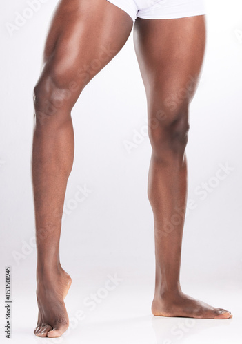 Man, legs and muscles in studio with fitness for workout progress, exercise goals and wellness. Bodybuilder, muscular athlete and flexing thighs for healthy body and gym target on white background