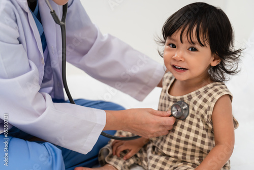 doctor using stethoscope to istening toddler's chest. baby health concept photo