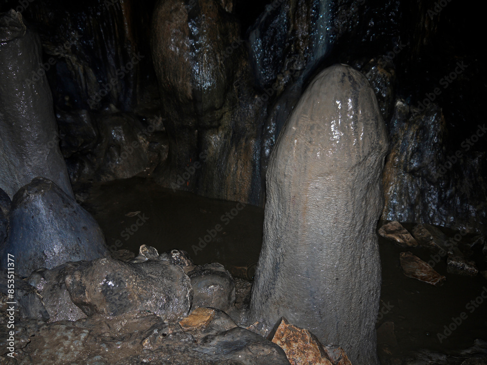 Hiking Inside the Dark cave environment with mineral deposits on the floor and walls Hiking Inside the Dark cave environment with mineral deposits on the floor and walls