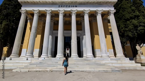 Slow motion follow shot of female tourist entering Zappeion Hall in Greece  photo