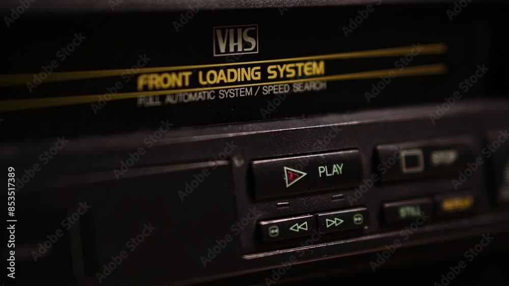 Loading VHS Video Cassette Tape and Pressing Play Button on VCR, Close Up Loading VHS Video Cassette Tape and Pressing Play Button on VCR, Close Up
