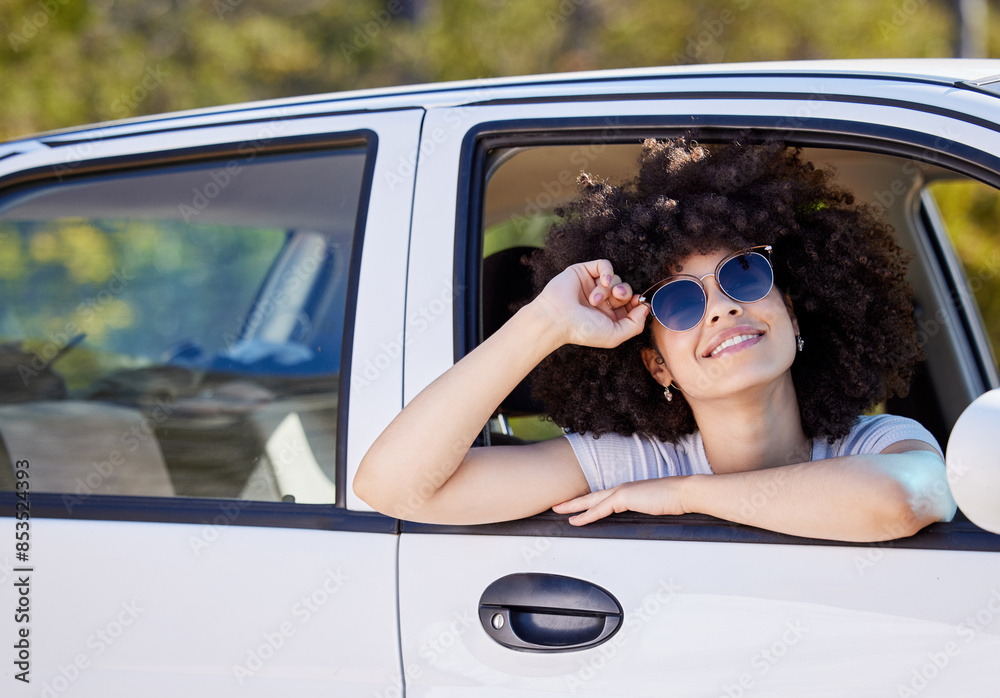 Naklejka premium Happy woman, portrait and car window with sunglasses on road trip, holiday or outdoor drive in nature. Female person with smile, afro or glasses in fashion for freedom, adventure or travel in vehicle