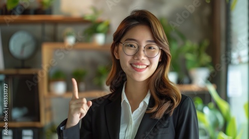 smiling young office lady, business entrepreneur pointing fingers left