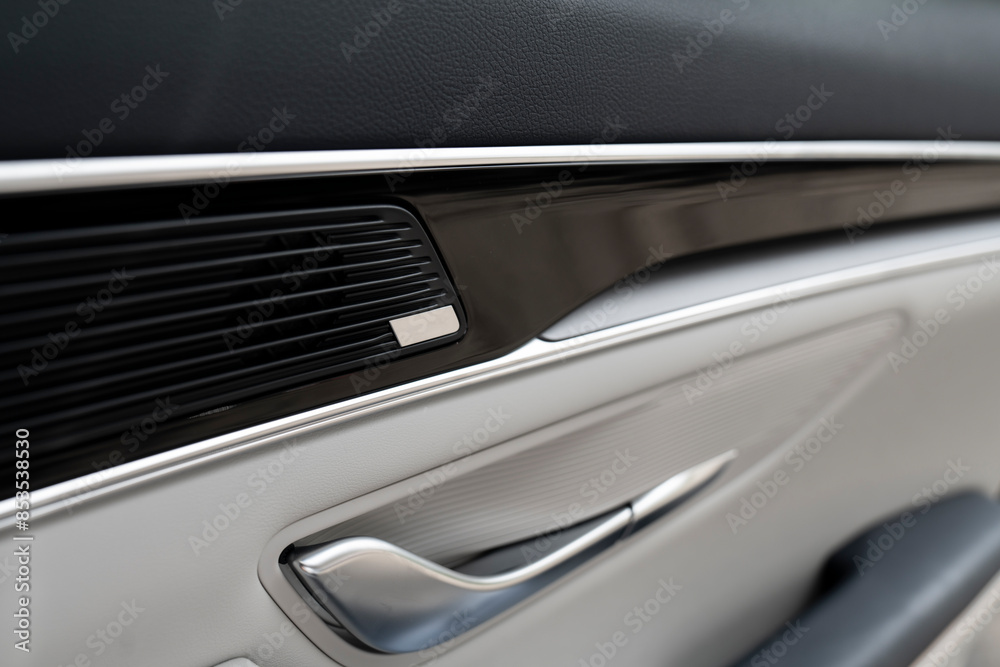 Door handle with Power seat control buttons of a luxury passenger car. White leather interior of the luxury modern car. Modern car interior details Door handle with Power seat control buttons of a luxury passenger car. White leather interior of the luxury modern car. Modern car interior details