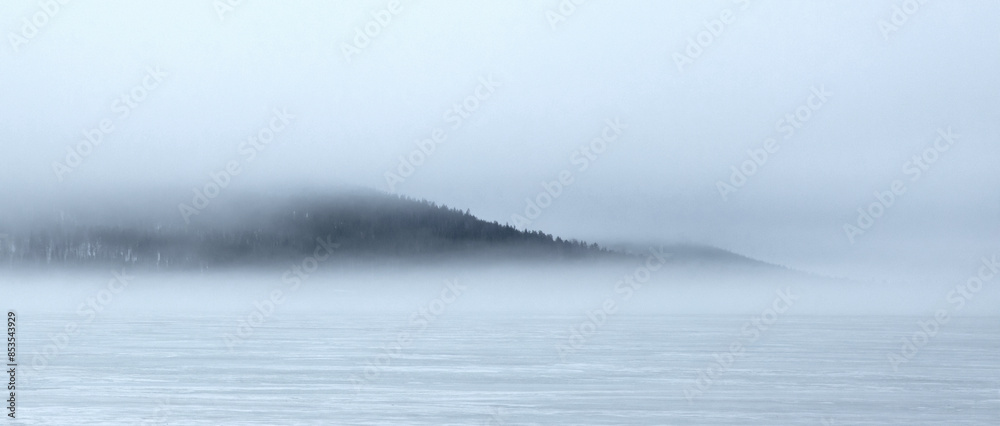 Small island in a Finnish lake, covered in myst Small island in a Finnish lake, covered in myst