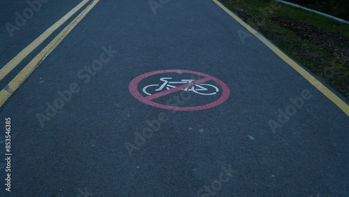 Bicycle sign on the road. Bike lane in the park.