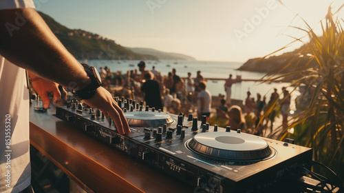 DJ mixing music on console mixer board at a luxury yacht party or at a beach party at sea, close-up of dj hands 