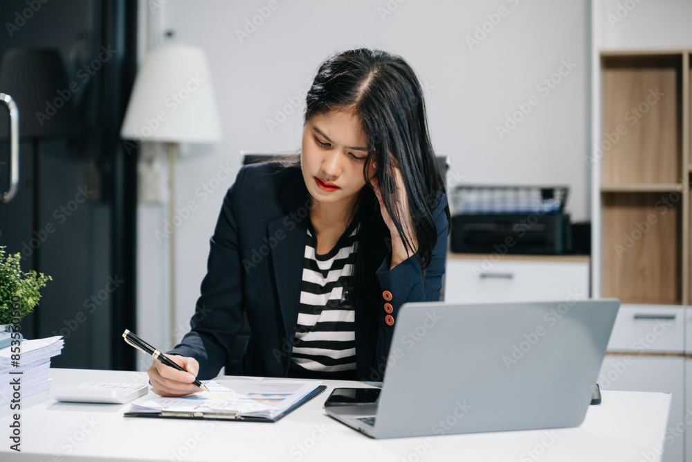 Woman who is tired and overthinking from working with tablet and laptop at modern office.. Woman who is tired and overthinking from working with tablet and laptop at modern office..