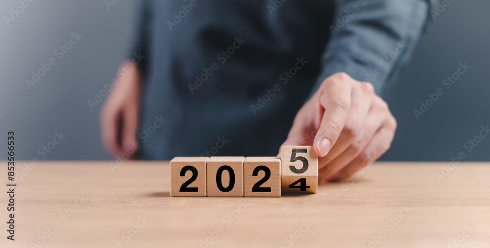 businessman hand assemble wooden block cube to status from 2024 to 2025 new year. goals trends 2025 analytical planning to growth strategy digital marketing, profit income and technical analysis
