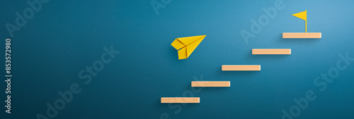 Fotografie Wooden block stacking as step stair with yellow paper plane and flag target icon