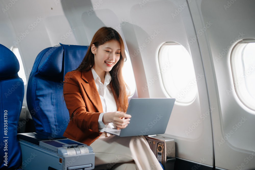 Asian woman sitting in a seat in airplane and looking out the window going on a trip vacation travel concept.Capture the allure Asian woman sitting in a seat in airplane and looking out the window going on a trip vacation travel concept.Capture the allure