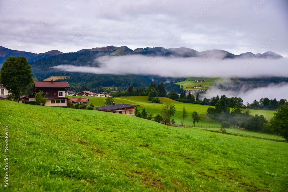 Morning mist rising over Alpine valley in autumn colorful countryside
Morning mist rising over Alpine valley in autumn colorful countryside