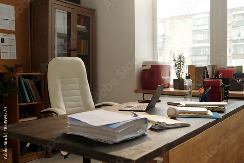 Wallpaper Mural White chair near desk with office stationary and documents in university office Torontodigital.ca