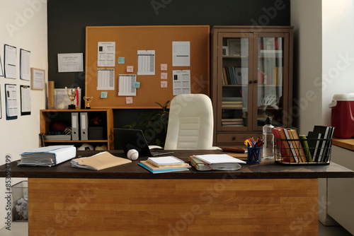 Desk with office stationary and documents in university office