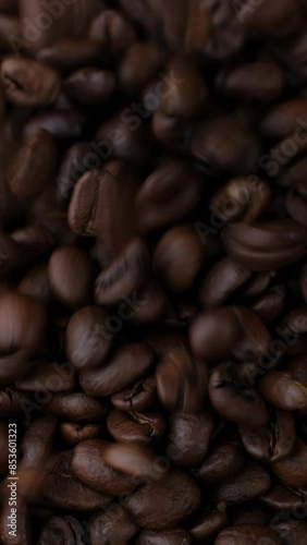 Roast coffee beans falling down in plate