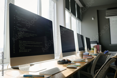 Wallpaper Mural No people shot of modern computer monitors with codes on screens in classroom, copy space Torontodigital.ca