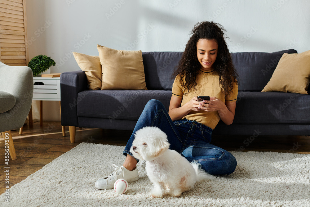 Woman sitting on floor, absorbed in cell phone, with dog. Woman sitting on floor, absorbed in cell phone, with dog.