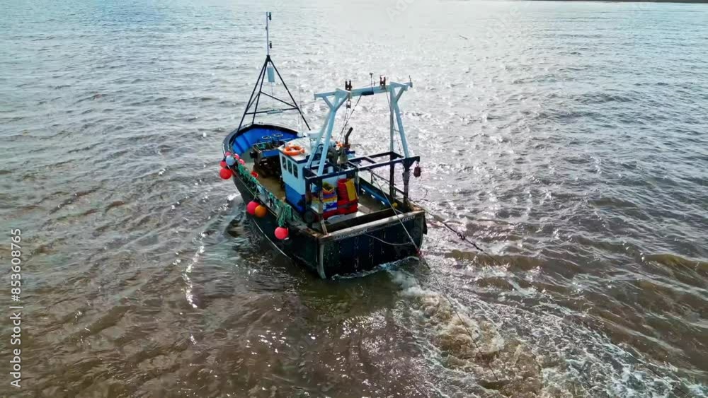 Fishing Boat, trawler, just offshore fishing, trawling with the coast, coastline visible Fishing Boat, trawler, just offshore fishing, trawling with the coast, coastline visible
