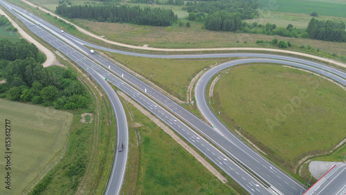 Konstfotografi Elevated view of rural highway junction with cars and green landscape