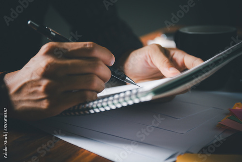 Student is diligently writing in notebook during  tutoring session, preparing for exams. education and the detailed work involved in studying and writing reports and letters.