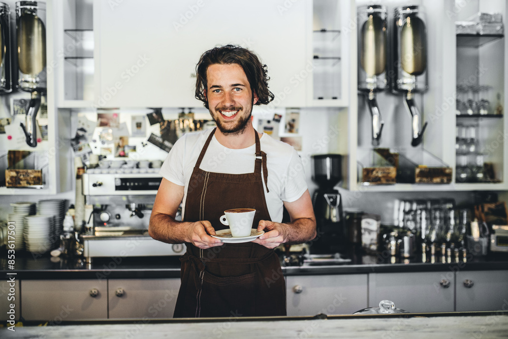 Handsome barista working in coffee shop, preparing coffee. University student working part-time in cafe. Handsome barista working in coffee shop, preparing coffee. University student working part-time in cafe.