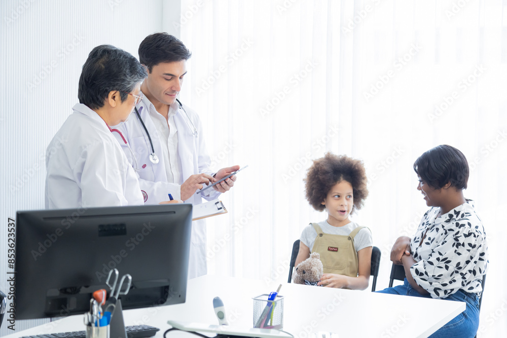 Team of pediatrician specialists diagnoses child's symptoms illness in medical reports, young doctor trainee consults senior advisor for child's health orthopedic room for medical care modern hospital Team of pediatrician specialists diagnoses child's symptoms illness in medical reports, young doctor trainee consults senior advisor for child's health orthopedic room for medical care modern hospital