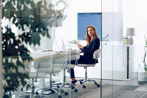 Businesswoman Working on Projects in Modern Glass Office Environment. photo