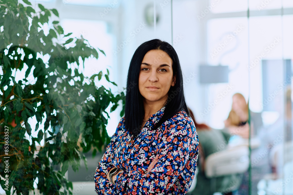 Portrait of a Confident Businesswoman with Crossed Arms in Her Office Environment. Portrait of a Confident Businesswoman with Crossed Arms in Her Office Environment.