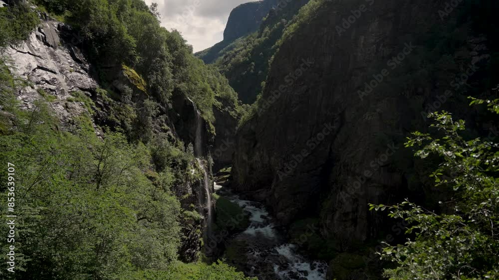 Deep mountain valley with flowing river in Norway, aerial view Deep mountain valley with flowing river in Norway, aerial view