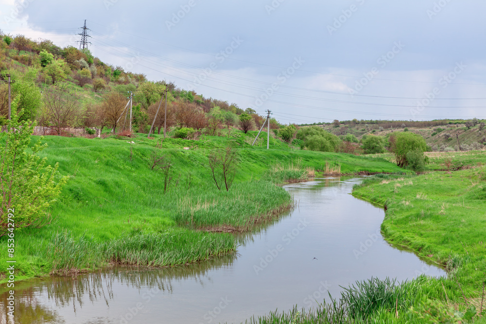 Scenic river flowing through lush green field. Winding river and countryside landscape Scenic river flowing through lush green field. Winding river and countryside landscape