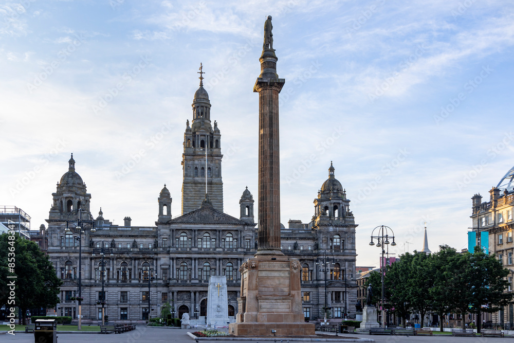 The Sir Walter Scott monument and City Chambers, located in George Square in Glasgow city centre, Scotland. The Sir Walter Scott monument and City Chambers, located in George Square in Glasgow city centre, Scotland.
