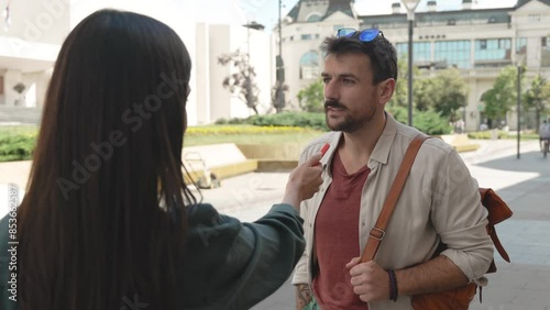 Young vlogger or journalist woman street interviewing freelancer expatriate or tourist male about life or business opportunities in the city. News reporter interview strangers about positive negative