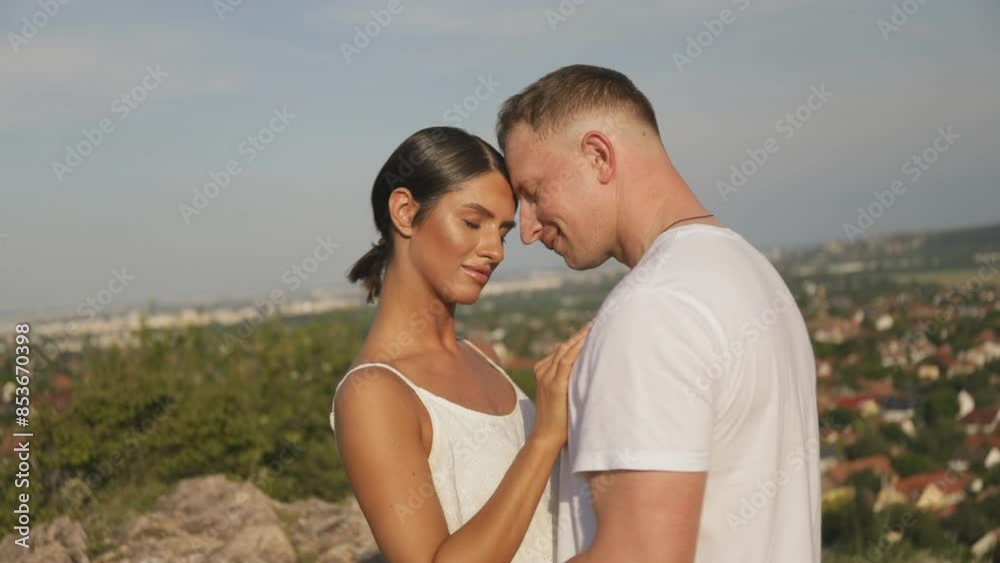 Smiling couple embracing in park on a sunny day. Couple in love. Happy day. Love story. Smiling couple embracing in park on a sunny day. Couple in love. Happy day. Love story.