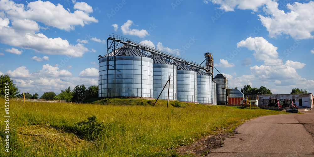Obraz premium silos on agro-industrial complex with seed cleaning and drying line for grain storage