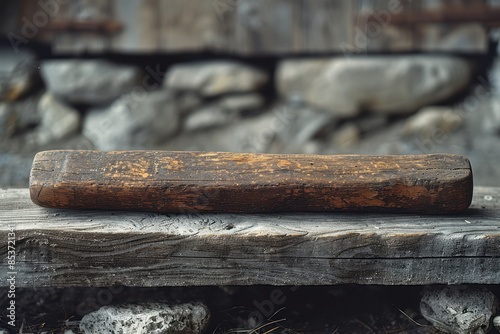 Elegant shot of an ancient wooden tool handle, displayed in a clean, minimalist setting,