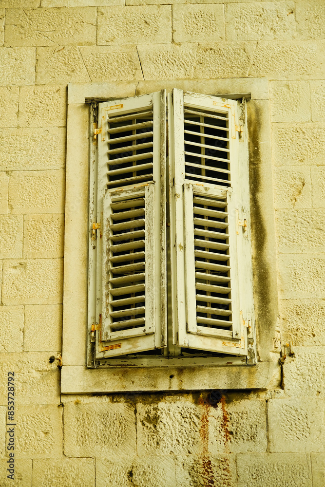 Fototapeta premium A window with two white slats and a white frame
