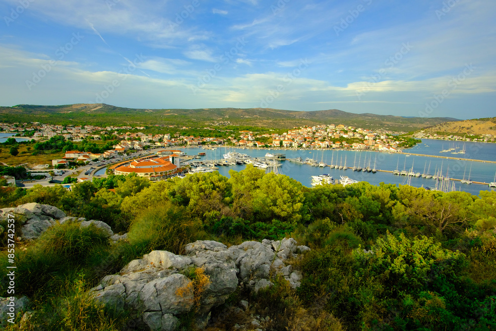 A beautiful view of a town with a large body of water in the background A beautiful view of a town with a large body of water in the background