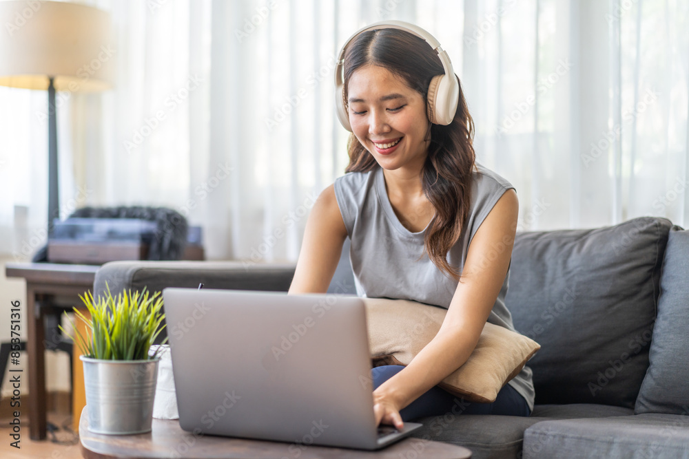 Young smiling asian woman happy relax use laptop conference work,learning, education, shopping, study online, webinar, online marketing, business, blog, digital internet advertising at home Young smiling asian woman happy relax use laptop conference work,learning, education, shopping, study online, webinar, online marketing, business, blog, digital internet advertising at home