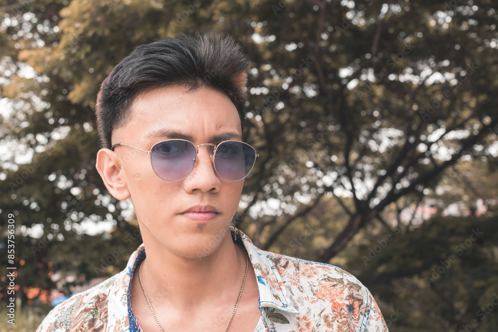 Young asian man in boho fashion wearing sunglasses outdoors Young asian man in boho fashion wearing sunglasses outdoors