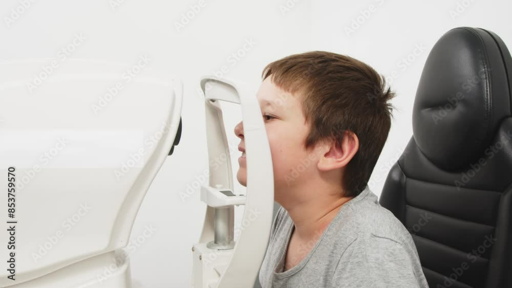 An ophthalmologist does an eye examination, working in a modern clinic with professional equipment. A girl checks a child's eyesight. An ophthalmologist does an eye examination, working in a modern clinic with professional equipment. A girl checks a child's eyesight.